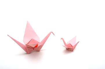 two pink origami crane birds on white