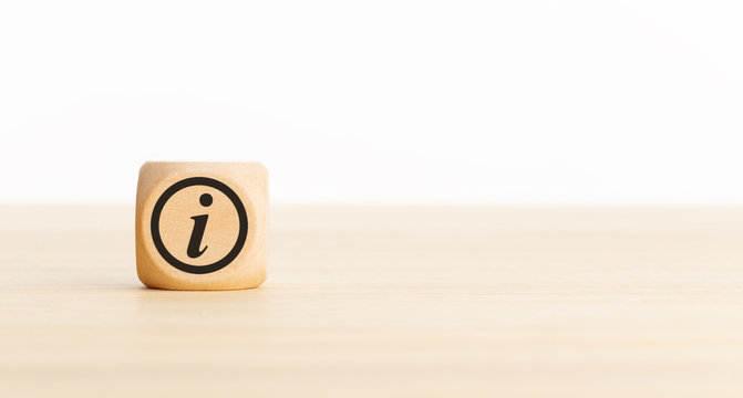 Info or information concept banner . Wooden block with info icon on desk. Copy space