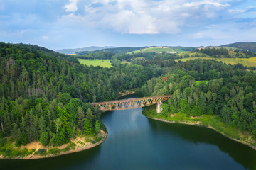 Fototapeta na wymiar Aerial view of Pilchowicki bridge - old steel truss railway bridge over the Pilchowickie Lake in Lower Silesia, Poland