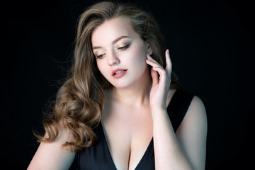 Obraz premium Young beautiful woman with natural makeup on black background. Beauty & Skin care concept. Plus size model.