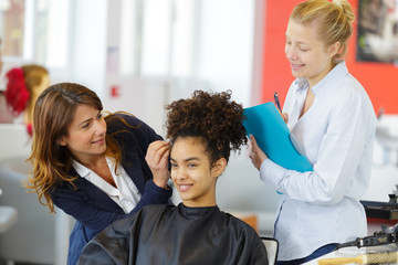 she is doing an afro style hairdo