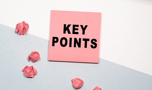 KEY POINTS the inscription on the pink sticker, next to scattered crumpled papers. white-and-blue background. Business concept