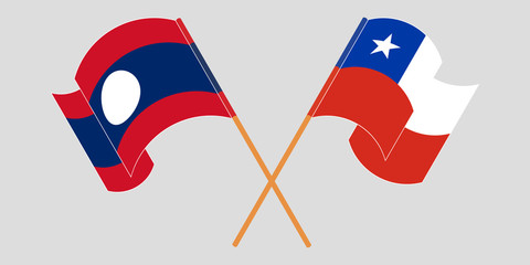 Crossed and waving flags of Laos and Chile