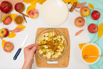 Autumn baking concept. step-by-step recipe for baking a traditional autumn Apple pie, copy the space on a light background. cut apples and mix with cinnamon and sugar