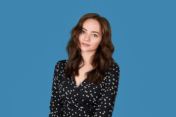 Portrait of a beautiful girl on a blue background