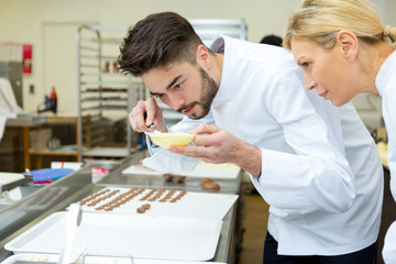 Obraz premium portrait of workers making chocolate