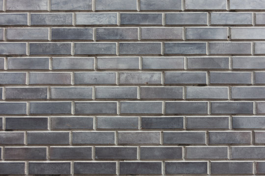 Fototapeta Grey brick background. For the presentation of something serious and significant. Modern backgrounds.