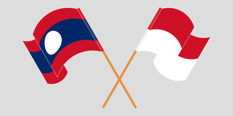 Crossed and waving flags of Laos and Indonesia