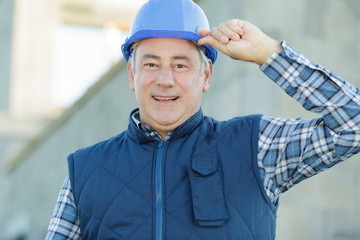 a builder with helmeted hands