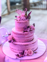 Beautiful wedding cake with cream With text MR MRS on top pink flowers roses