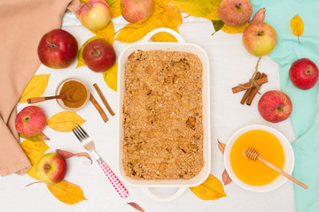 Apple crisp crumble for home cooking on a light background top view. traditional autumn dessert with cinnamon and oatmeal, honey.