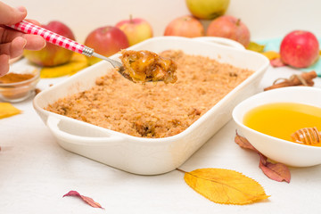 Apple crisp crumble for home cooking on a light background top view. traditional autumn dessert with cinnamon and oatmeal, honey.