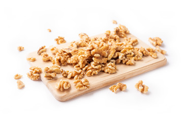 Peeled nuts on a wooden board on a white background