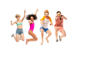 Excited multiethnic friends in sunglasses and flip flops jumping isolated on white