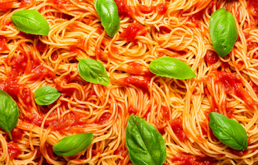 Spaghetti with tomato sauce and basil, top view. Spaghetti background.