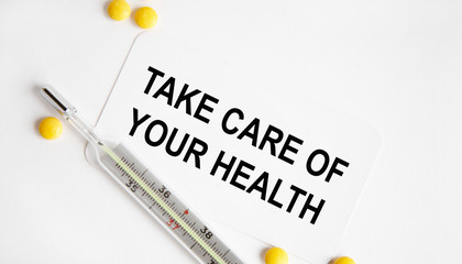 Obraz premium Take care of your health. The inscription is made in a notebook, next to a notebook tablet and stethoscope.