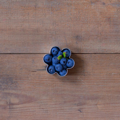blueberries on brown wooden background