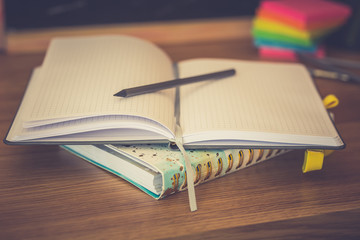 School supplies on black board background. Back to school concept