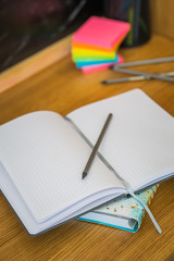 School supplies on black board background. Back to school concept