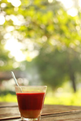Hot milk tea is placed on a wooden table in the garden. Sense the focus.