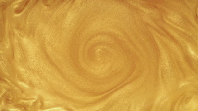 Yellow swirl mixing gold paint, animation effect for transition. Gold background