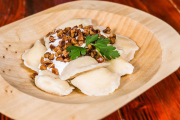 Traditional Slovak food - Bryndzove pyrohy with bacon on plate. The food in the restaurant. Food styling and restaurant meal serving.