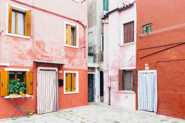 Fototapeta na wymiar Island of Burano, Venice, Italy. Beautiful corner of the island. Postcard from Burano. Charming houses.