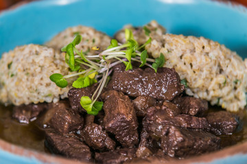 Game meat and rice decorated with herbs. The food in the restaurant. Food styling and restaurant meal serving.