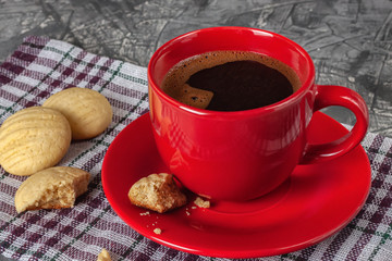 A cup of black aromatic freshly brewed coffee with homemade cookies