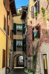 Fototapeta na wymiar Old narrow streets of the city of Torri del Benaco. Northern Italy, Lake Garda