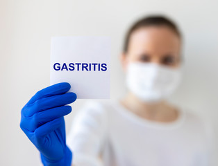 Doctor keeps a paper with the diagnosis - gastritis. Medical concept.