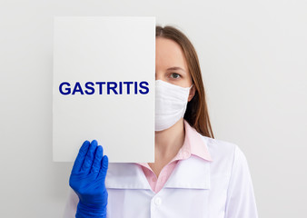Doctor keeps a paper with the diagnosis - gastritis. Medical concept.