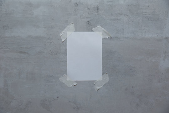 A Sheet Of Paper With Mock Up Taped To The Wall