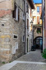 Naklejka premium Old narrow streets of the city of Torri del Benaco. Northern Italy, Lake Garda