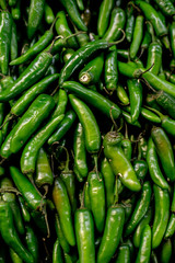 green tree chili peppers at a market stall