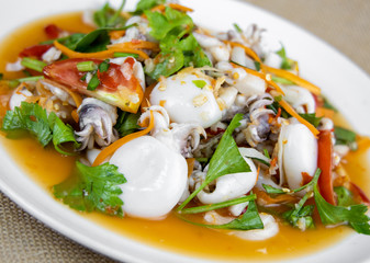 Thai Spicy Squid Salad on Burlap Fabric isolated