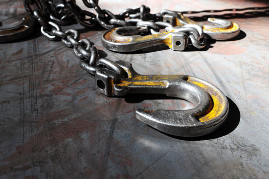 Load chain sling on sheet steel. Steel chain and crane hooks.