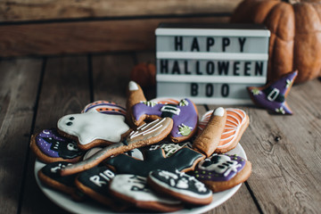 Halloween holiday concept. Pumpkin. Autumn mood. Happy Halloween. White lightbox on the wooden table with autumn background. Halloween cookies. 