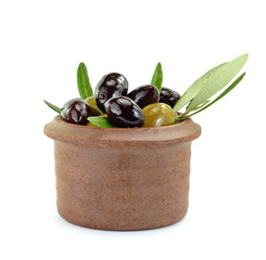 Different types of olives in a clay bowl isolated on white background