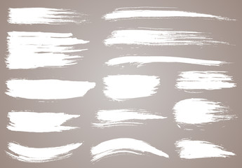 Obraz premium Paint brush. White ink grunge brush strokes. Vector paintbrush set. Grunge design elements. Painted ink stripes