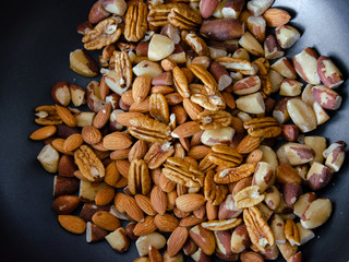 top view of a bunch of different kinds of nuts, peca, almond, chestnut