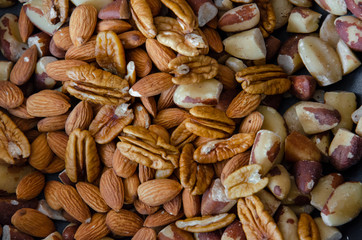 close up on a bunch of different kinds of nuts, pecan, almond, chestnut