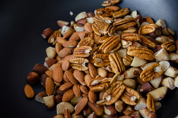 top view of a bunch of different kinds of nuts, peca, almond, chestnut