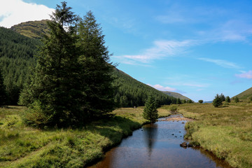 Fototapeta na wymiar Small Highland River and Mountain in Scotland