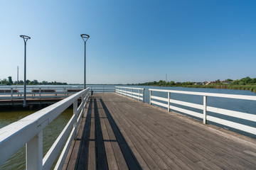Fototapeta premium Pier on a small lake in the town of Znin on a sunny summer day