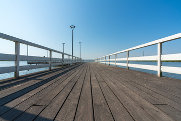 Fototapeta premium Pier on a small lake in the town of Znin on a sunny summer day
