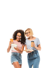 Multiethnic students looking at smartphone while holding coffee to go isolated on white