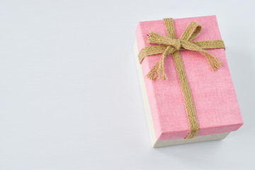 Pink gift box with bow on a white background