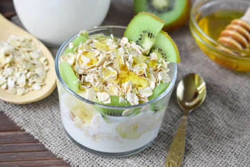 in a glass of oatmeal with kiwi and bananas close up