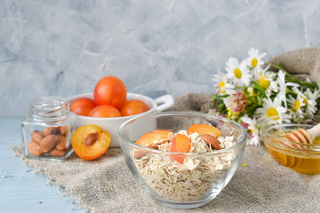 Oatmeal with almonds and apricots in a clear glass bowl